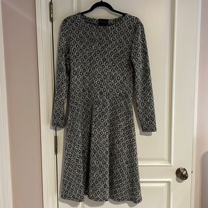 Black and beige skater style knit dress. Sleek design